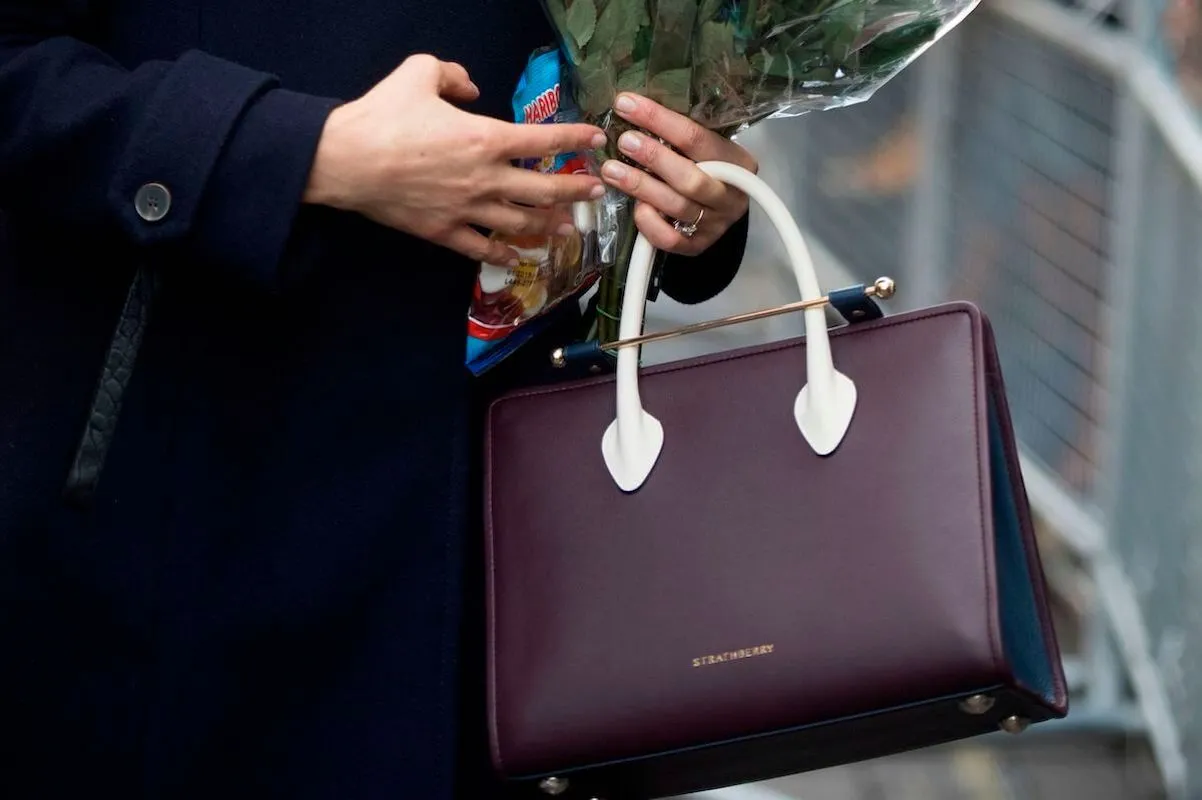 Meghan Markle carrying a Strathberry handbag