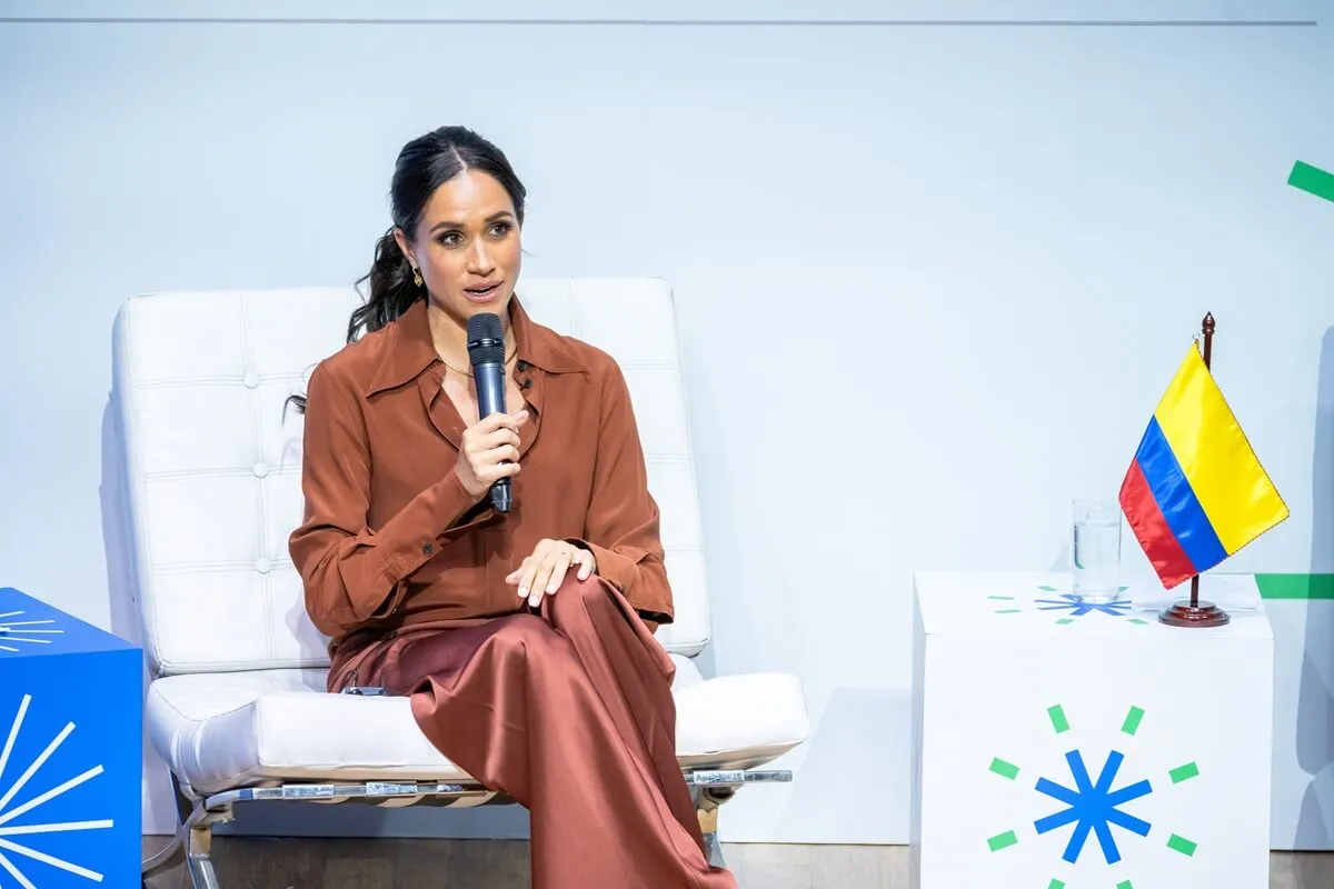 Meghan Markle wearing a silk brown shirt by Victoria Beckham at EAN University in Bogota, Colombia