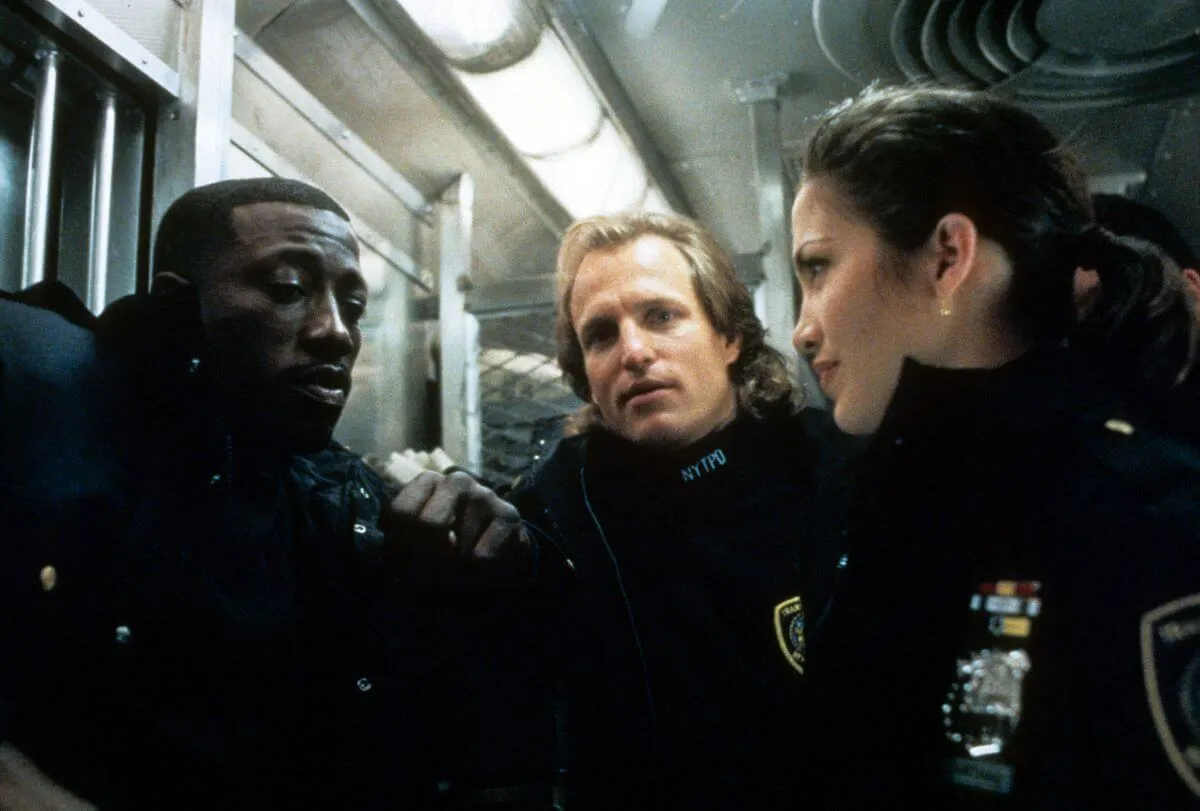 Wesley Snipes, Woody Harrelson, and Jennifer Lopez wear police uniforms on a train on the set of 'Money Train.'