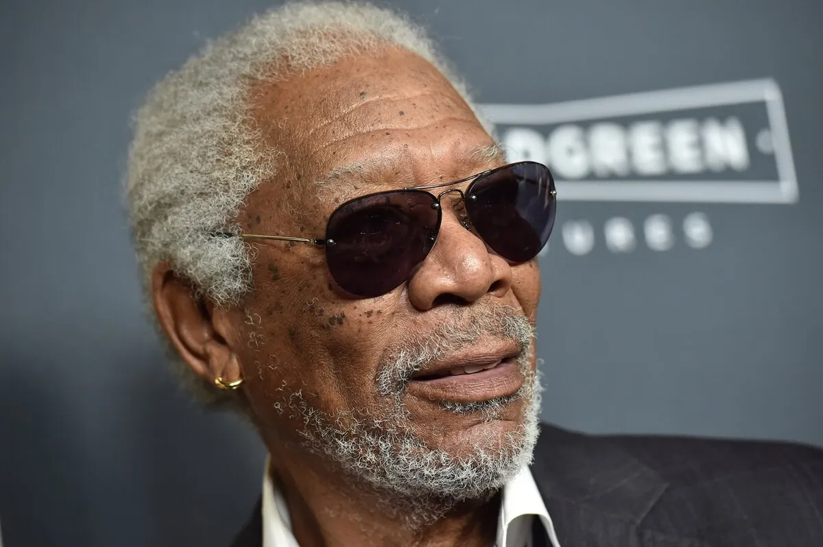 Morgan Freeman posing at the premiere of 'Just Getting Started' wearing a suit and sunglasses.