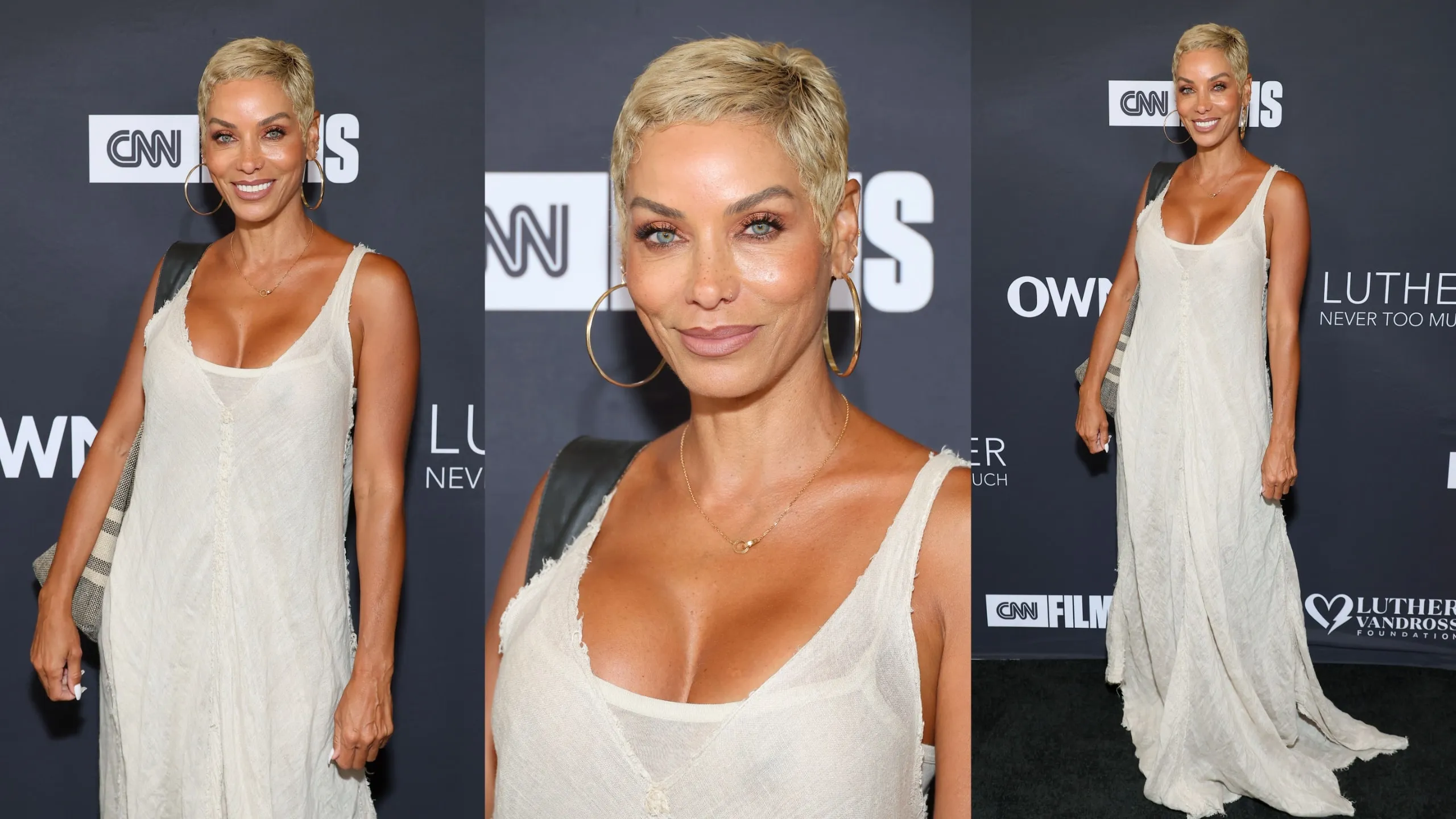 Wearing a white dress, Nicole Murphy poses for photos on the red carpet