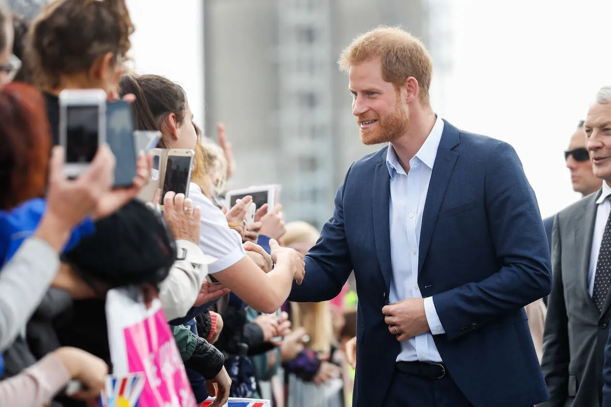Prince Harry, whose plan to win back the British public involves the 2027 Invictus Games, in New Zealand greeting crowds.