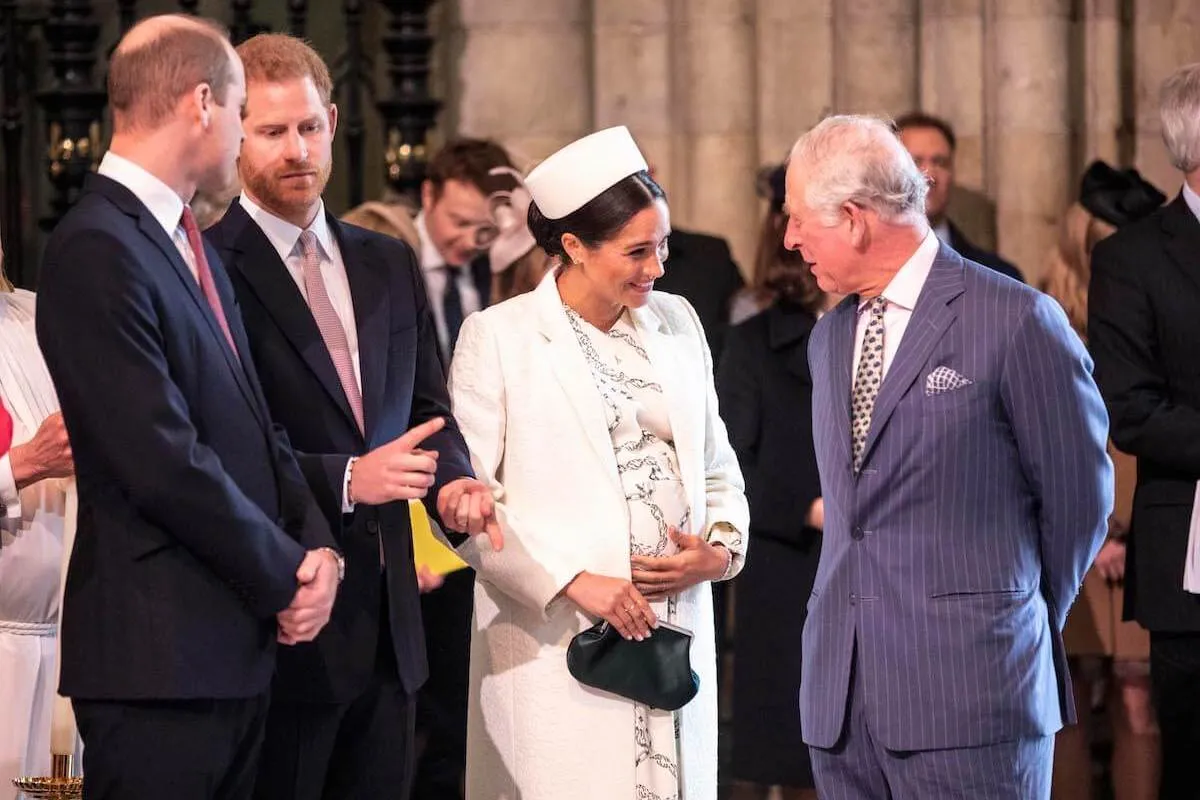 Prince William, Prince Harry, Meghan Markle, and King Charles III stand together at Westminster Abbey. 