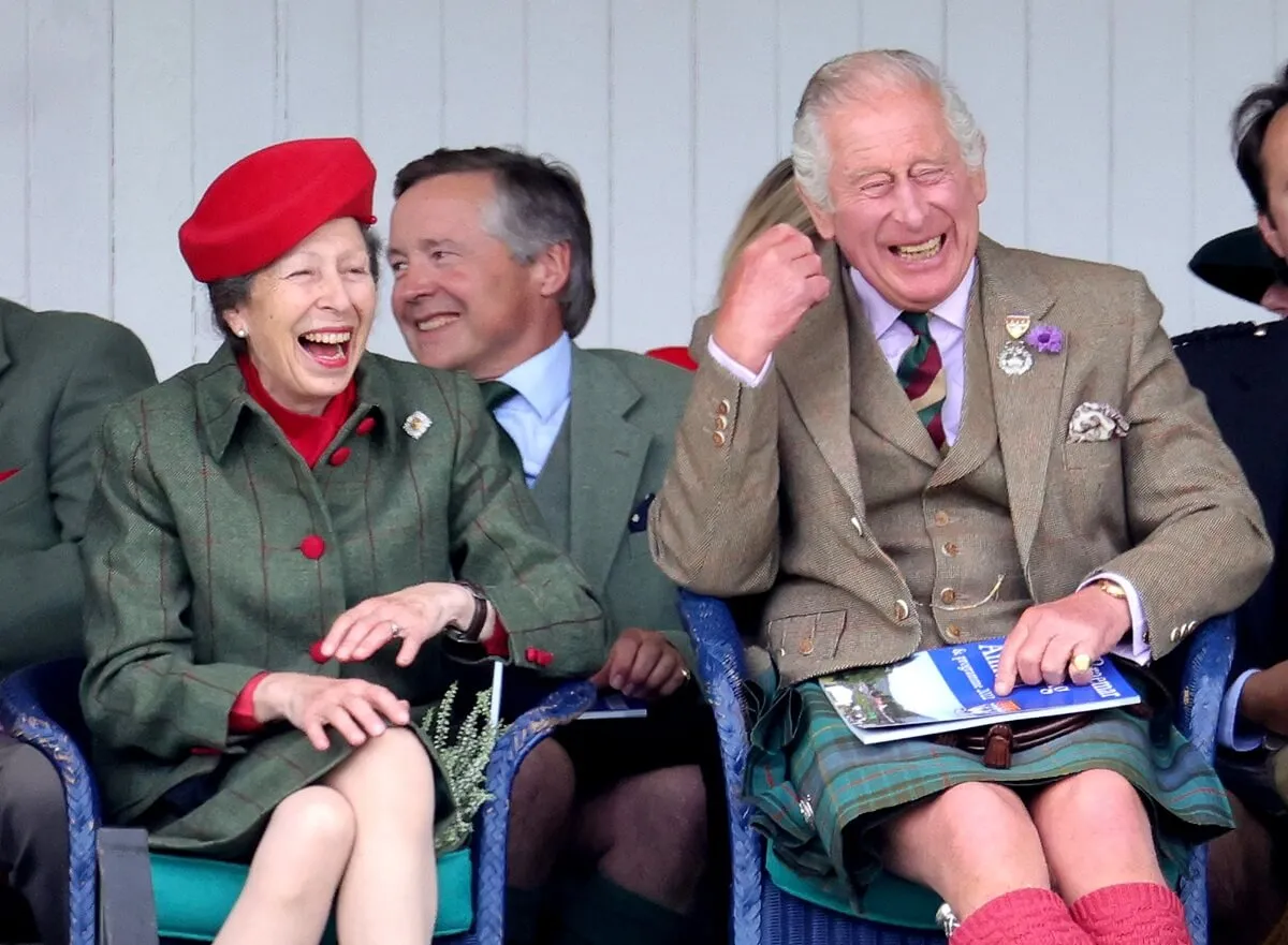 Princess Anne and King Charles III laughing during the Braemar Highland Gathering at the Princess Royal & Duke of Fife Memorial Park in Scotland