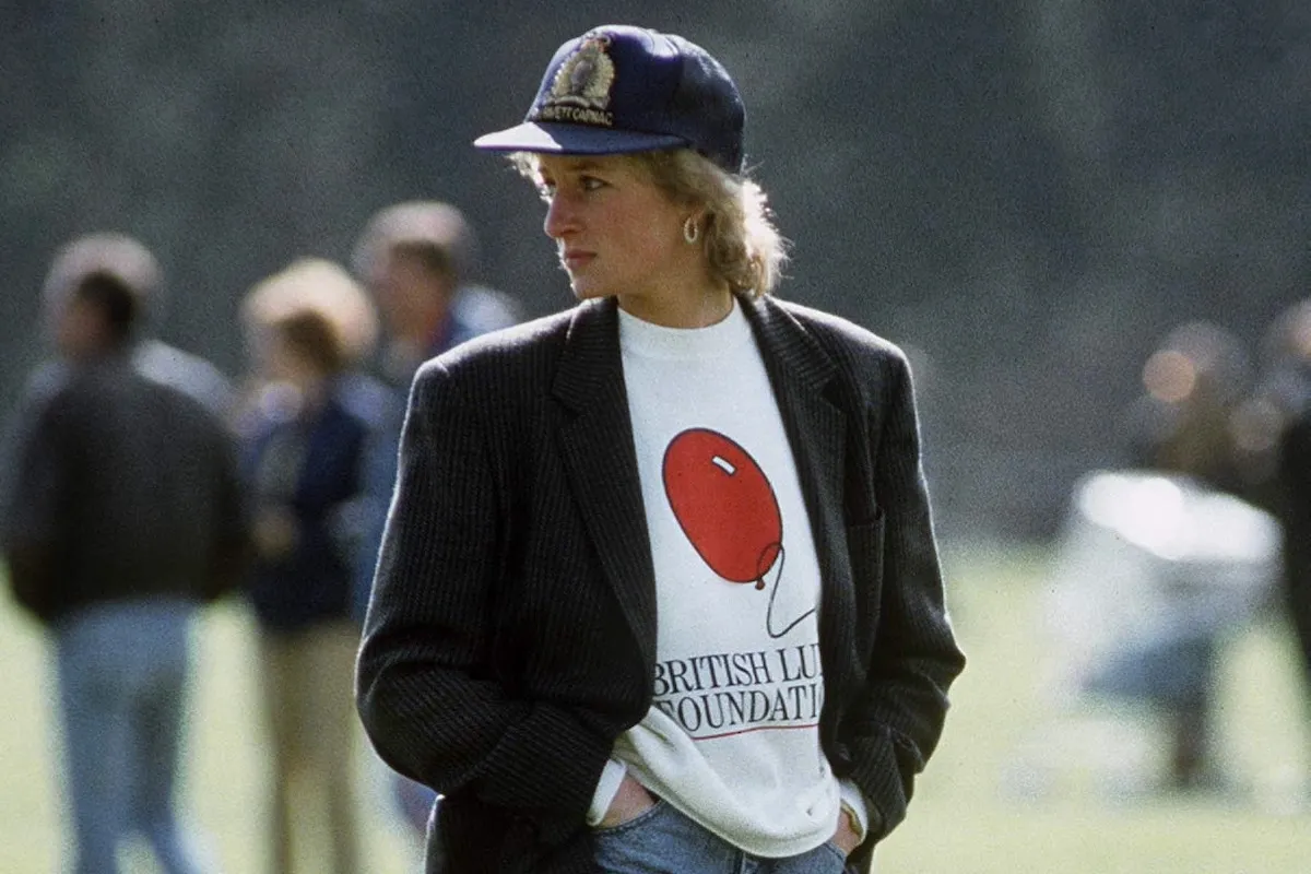 Princess Diana looks on in one of her iconic fashion items, a charity sweatshirt