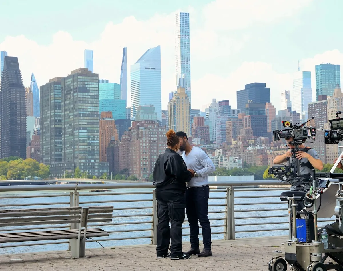 Tory Kittles and Queen Latifah film a scene for The Equalizer on Long Island City, Queens, with the NYC skyline behind them