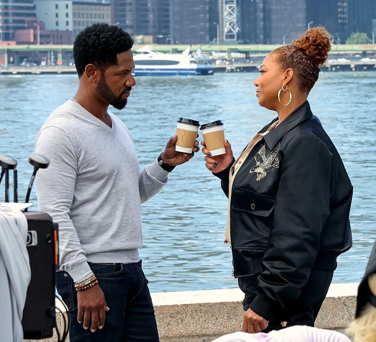 Tory Kittles and Queen Latifah film a scene for The Equalizer on Long Island City, Queens, with the NYC skyline behind them