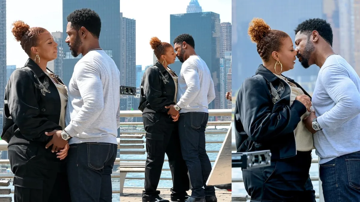 Tory Kittles and Queen Latifah kiss while filming a scene for The Equalizer on Long Island City, Queens, with the NYC skyline behind them