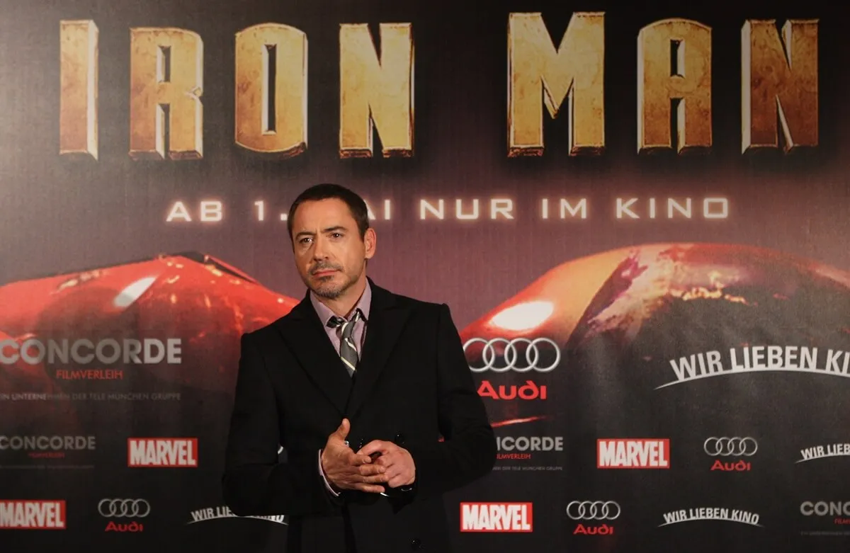 Robert Downey Jr. posing in a suit at the 'Iron Man' premiere.