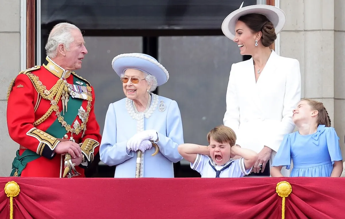 King Charles and Queen Elizabeth II stand on the balcony of Buckingham Palace as Prince Louis has a meltdown