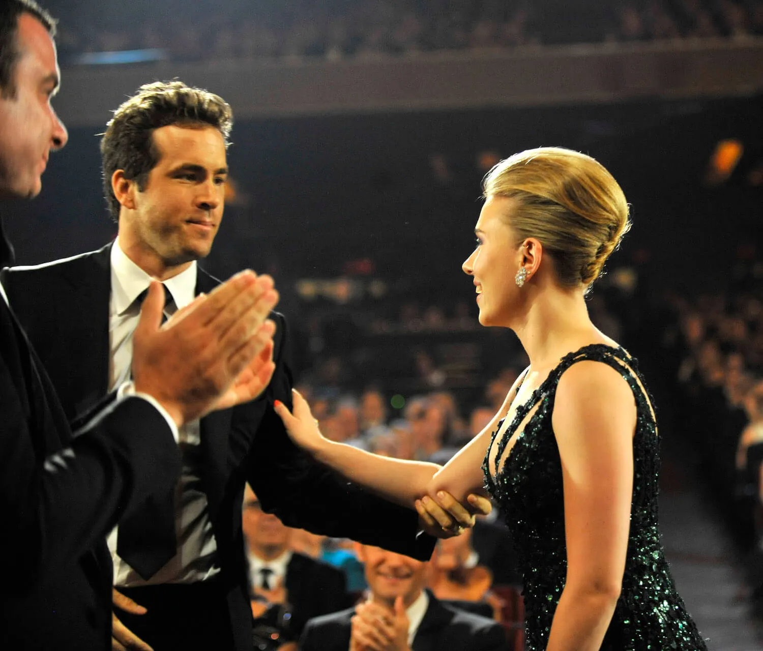 Scarlett Johansson putting her arm on Ryan Reynolds' shoulder and looking at him at the 64th annual Tony Awards in 2010