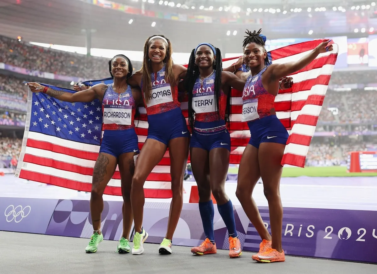 Women's 4x100m team Sha'carri Richardson, Twanisha Terry, Gabrielle Thomas, and Melissa Jefferson hold up an American flag after winning the gold medal