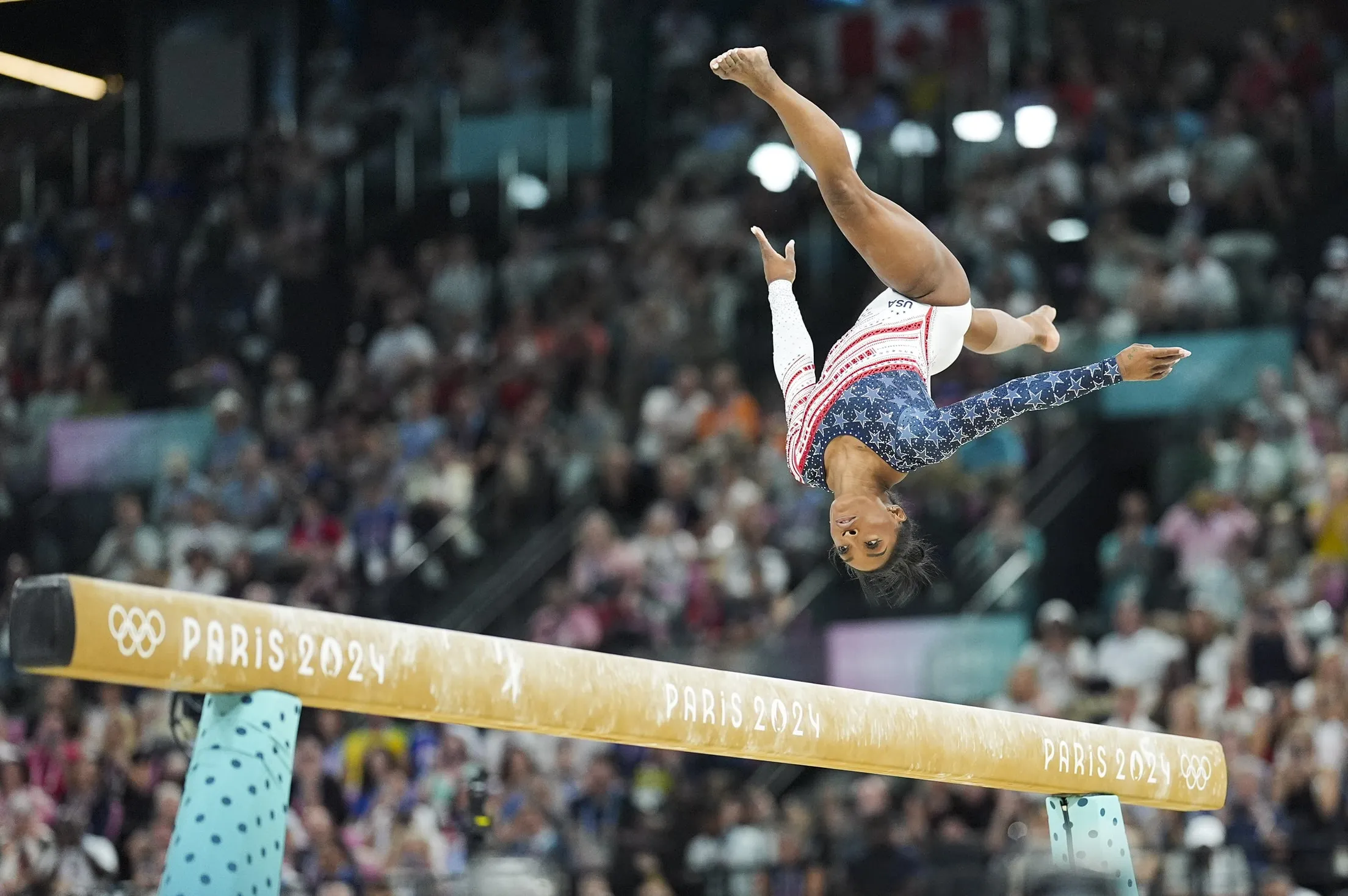 Gymnast Simone Biles competes on the beam at the 2024 Summer Olympics