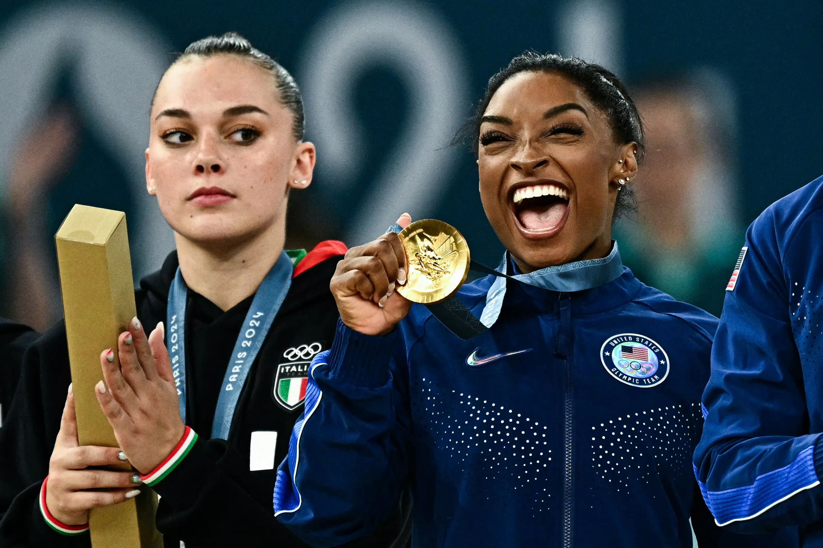 Gymnast Simone Biles poses with the gold medal during the podium ceremony