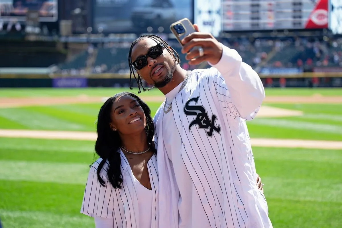 Simone Biles and Jonathan Owens on the field before Owens threw out a first pitch at a Chicago White Sox game