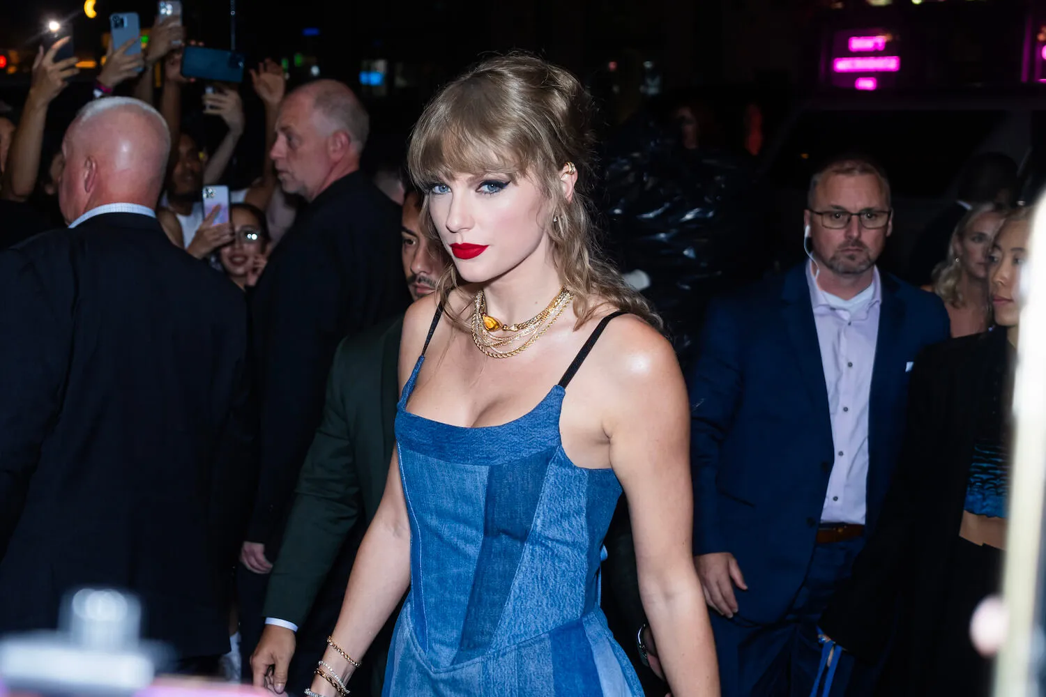 Taylor Swift wearing a blue dress and looking at the camera in New York City in 2023