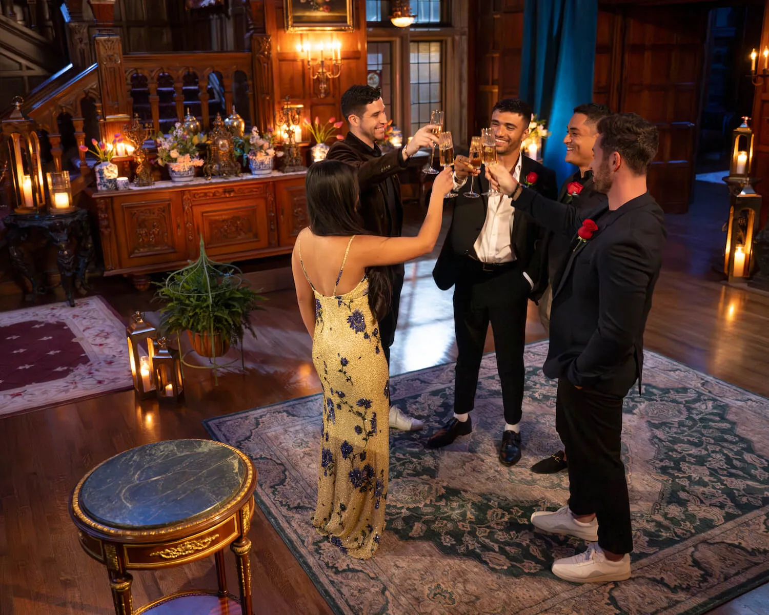 Jenn Tran, Jonathon Johnson, Devin Strader, Marcus Shoberg, and Jeremy Simon toasting after a rose ceremony in 'The Bachelorette' Season 21