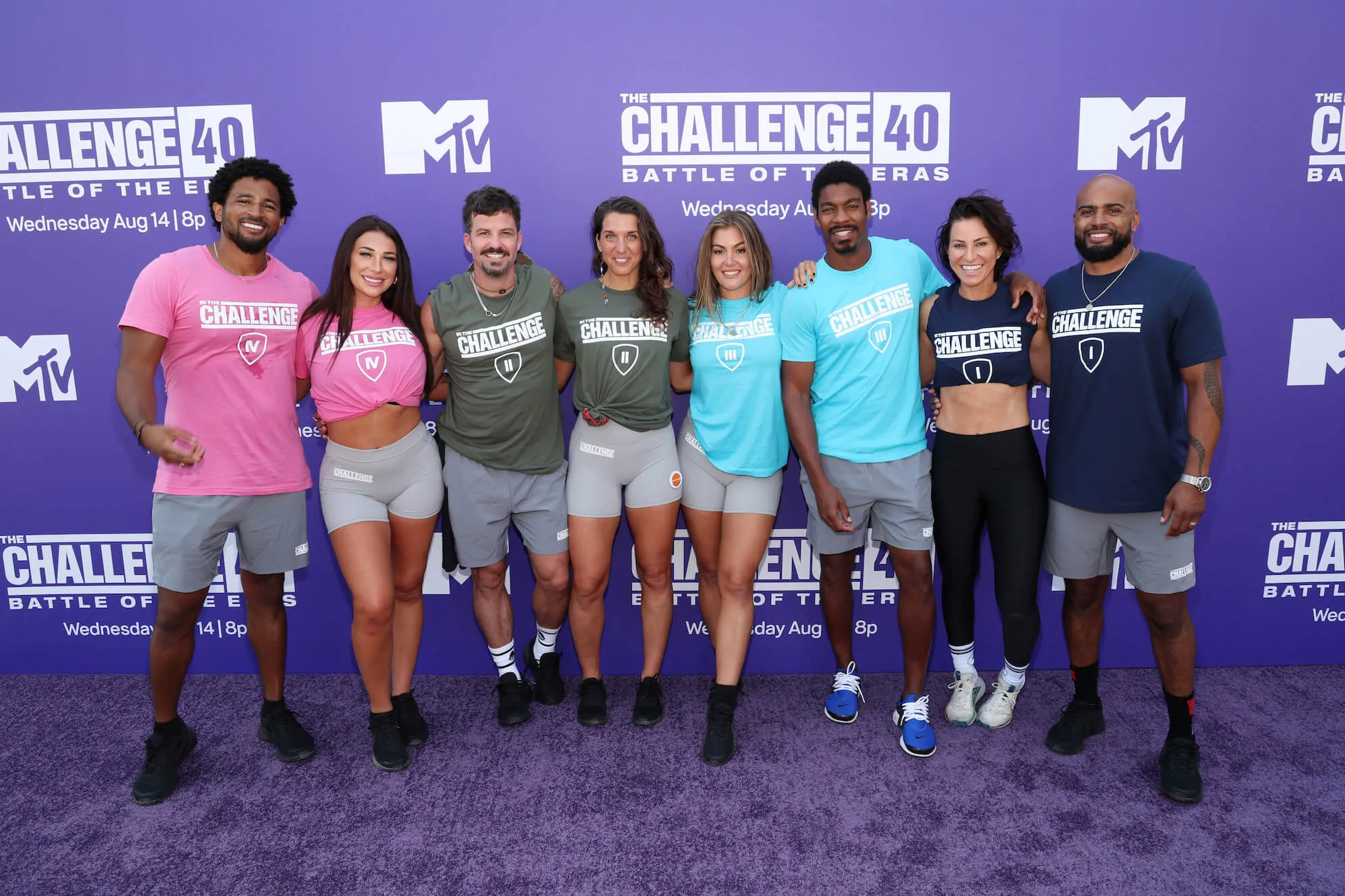 (L-R) Kyland Young, Olivia Kaiser, Johnny 'Bananas' Devenanzio, Emily Schromm, Tori Deal, Leroy Garrett, Rachel Robinson, and Darrell Taylor stand together and pose at MTV's 'The Challenge 40: Battle Of The Eras' LA event at Los Angeles Memorial Coliseum