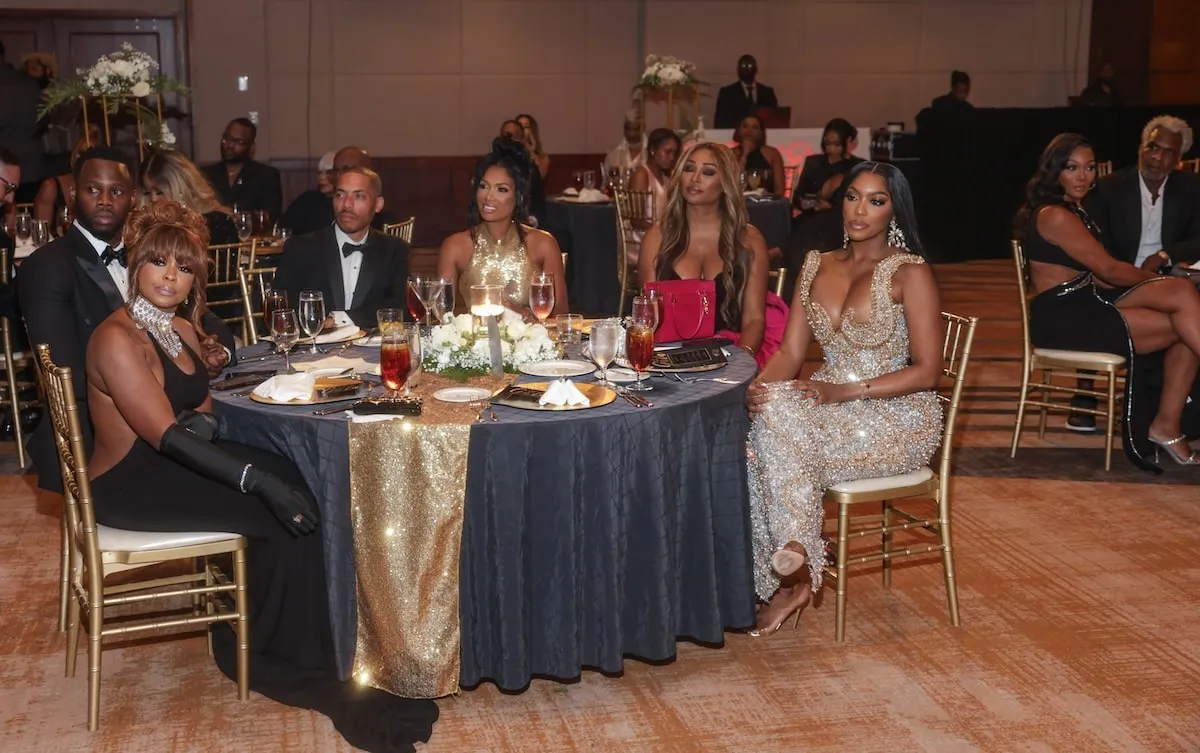 The cast of The Real Housewives of Atlanta sits at their table at Charles Oakley's fundraising event