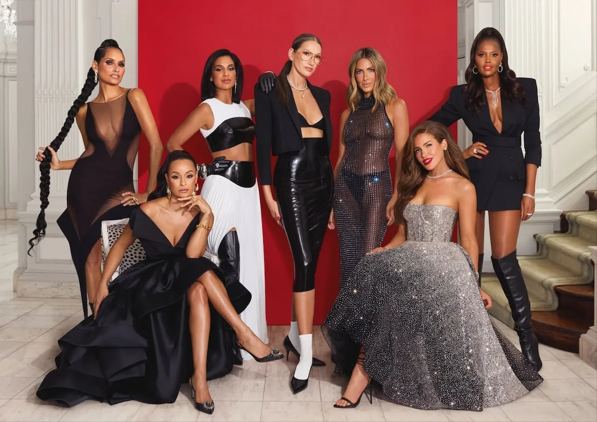 Wearing black outfits, Racquel Chevremont, Sai De Silva, Jessel Taank, Jenna Lyons, Erin Lichy, Brynn Whitfield, and Ubah Hassan pose for the cast photo for 'The Real Housewives of New York City'