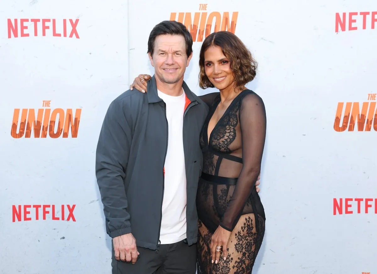 Stars of The Union Mark Wahlberg and Halle Berry hold each other on the red carpet