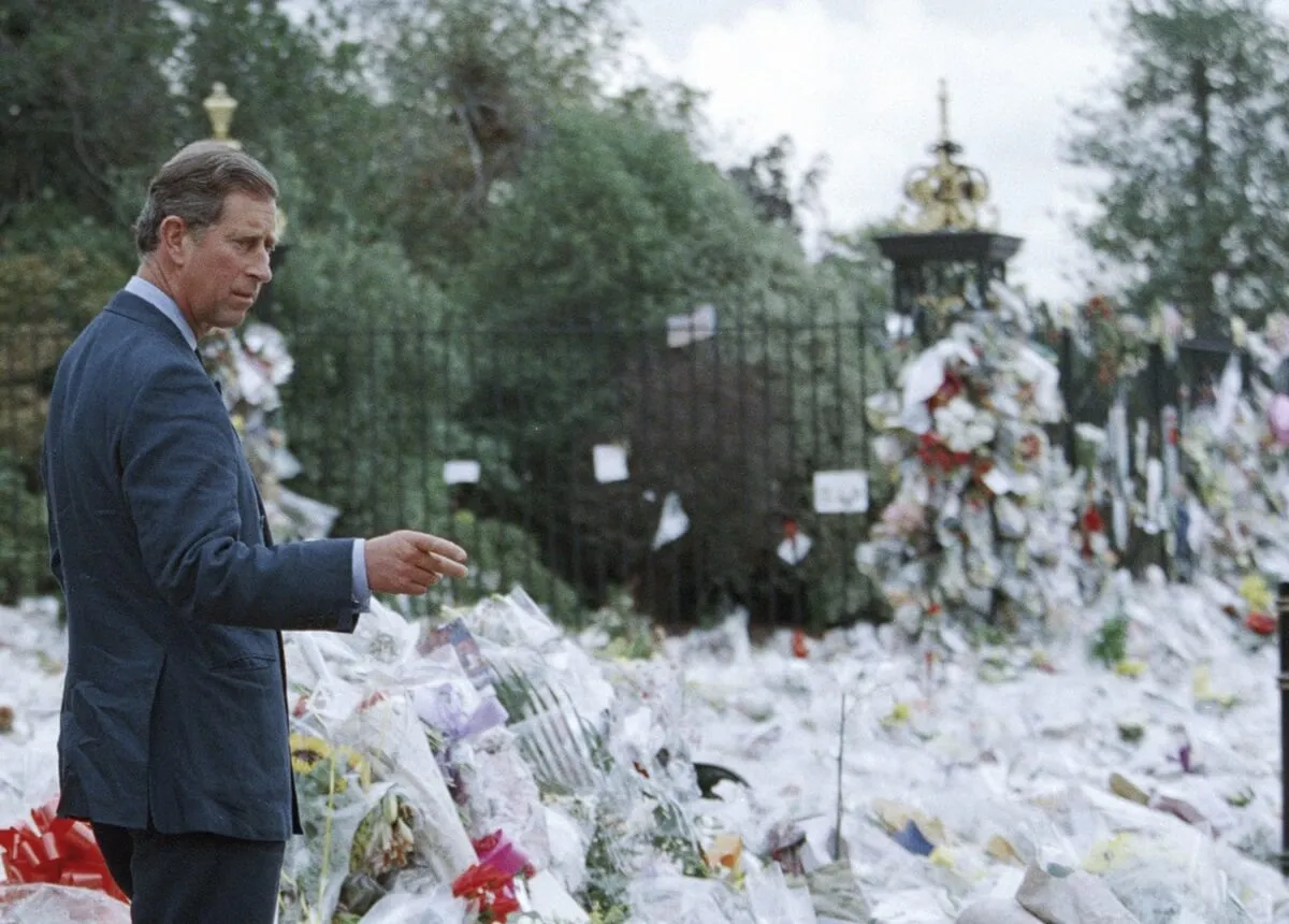 Then-Prince Charles viewing floral tributes to Princess Diana