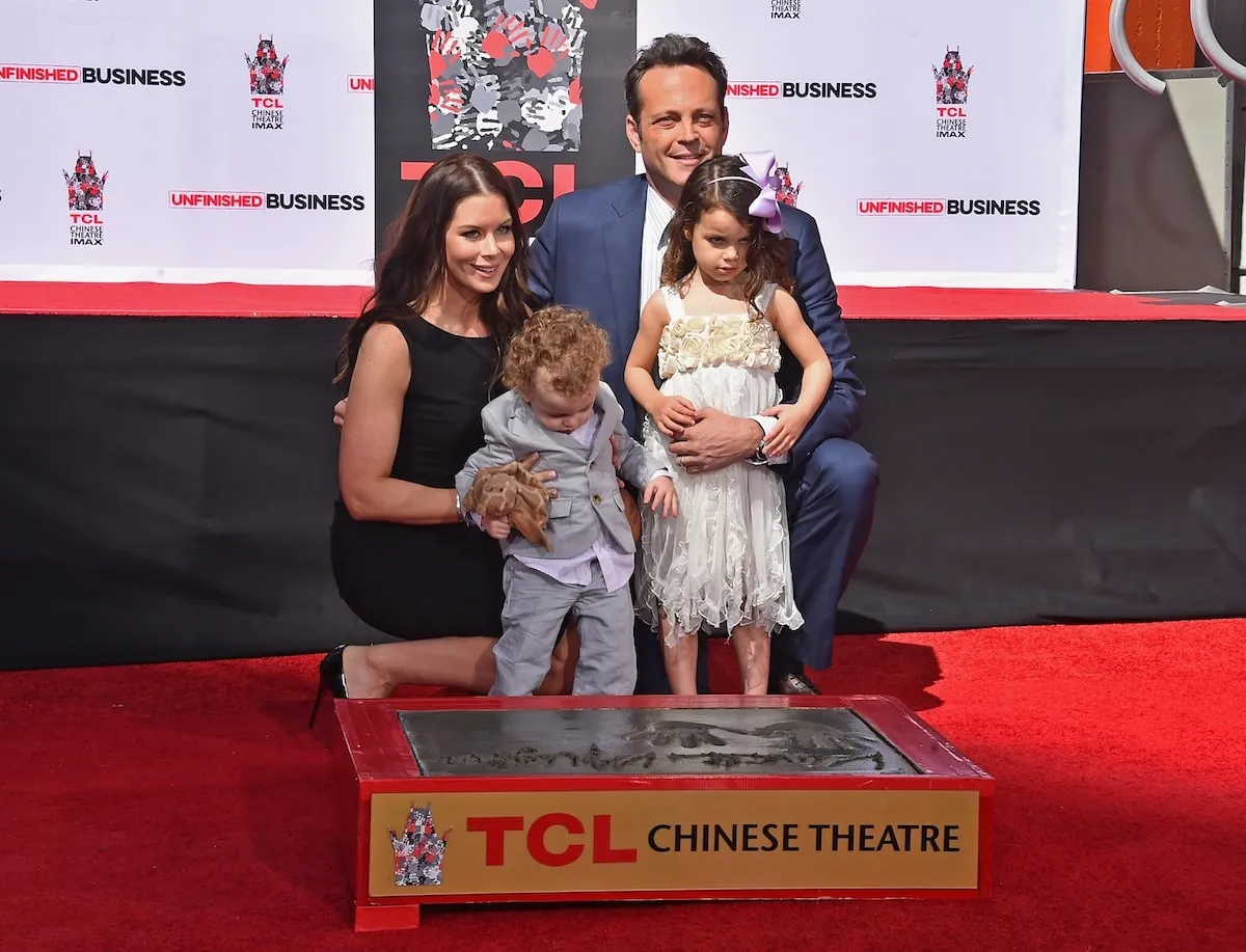 Kyla Weber, Vernon Vaughn, Lochlyn Vaughn, and Vince Vaughn pose by his hand and foot print in Hollywood