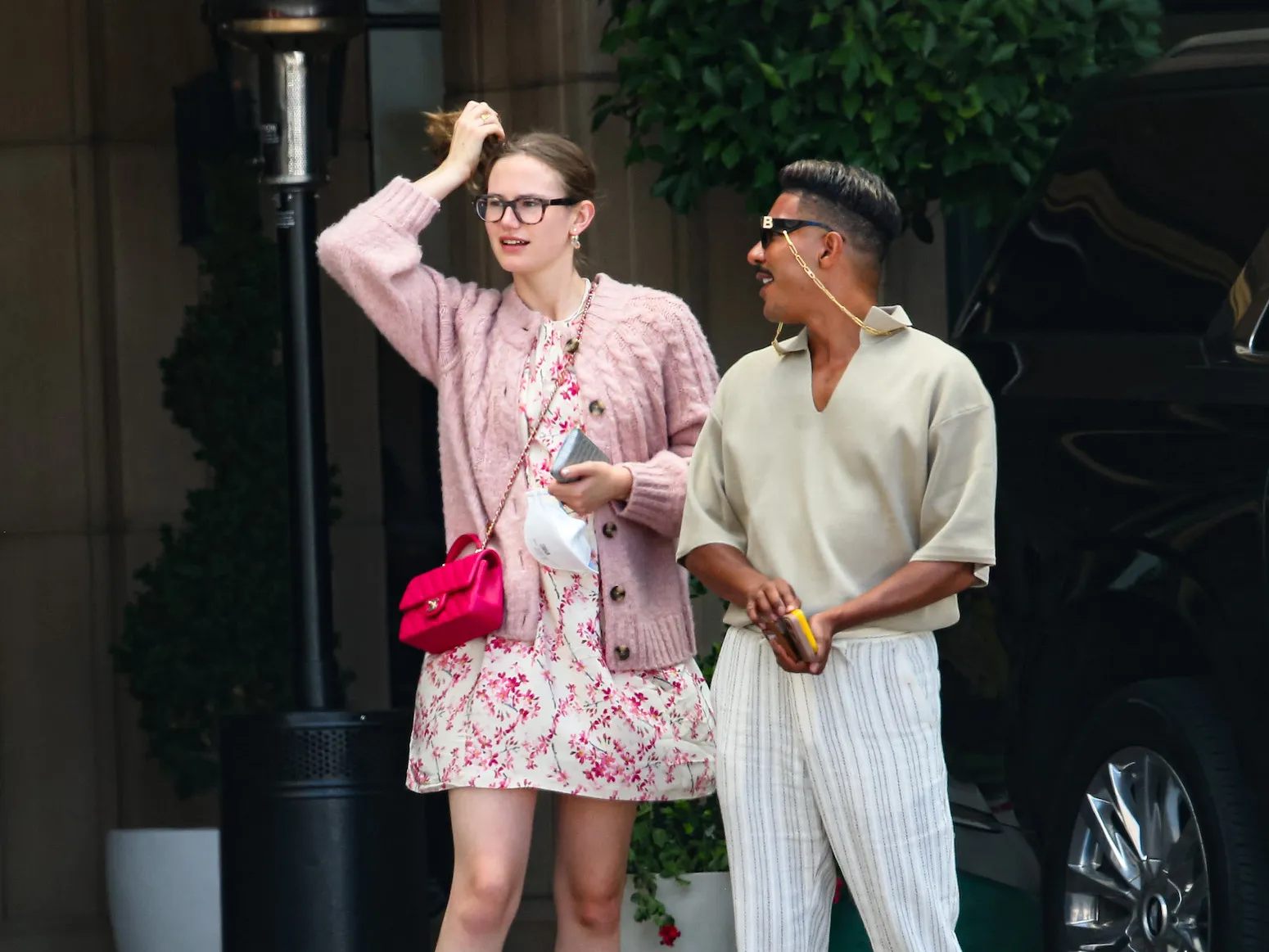 Violet Affleck is seen on June 13, 2024 in Los Angeles, California, standing next to a man on the street and holding her hair