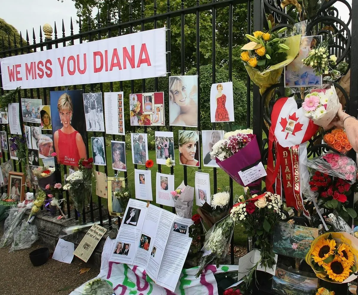 Well wishers place flowers in tribute of Princess Diana on the fence at Kensington Palace on Aug. 31, 2007 in London, England on the 10th anniversary of her death