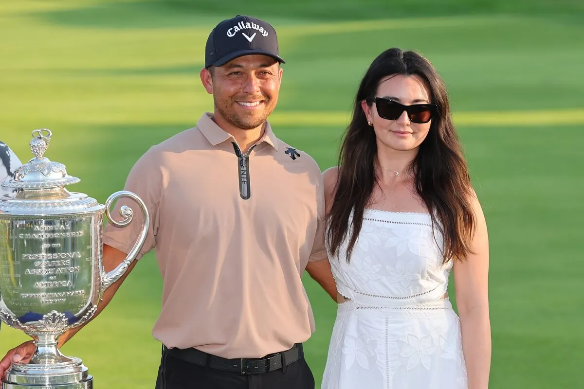 Xander Schauffele and his wife, Maya Schauffele, pose with the Wanamaker Trophy after winning the 2024 PGA Championship