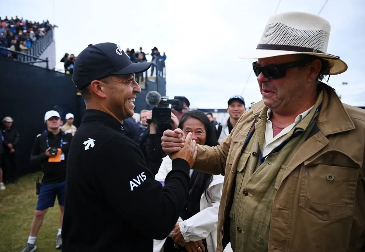 Xander Schauffele is congratulated by his father, Stefan Schauffele, on the 18th green at The 152nd Open championship