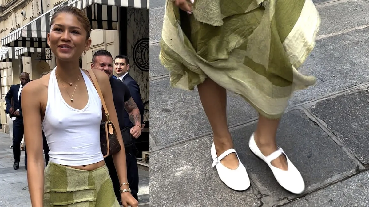 Wearing a white top and green skirt, Zendaya greets paparazzi outside of her Paris hotel