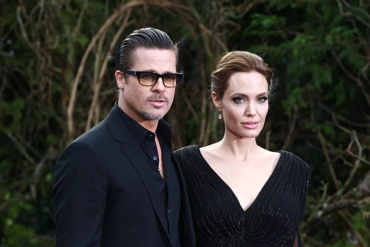 Angelina Jolie and Brad Pitt dressed in matching-colored outfits at a private reception for Disney's 'Maleficent'.