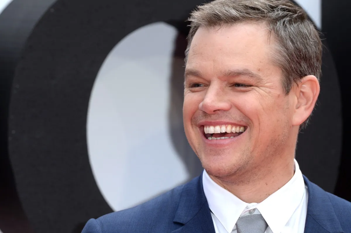 Matt Damon posing in a suit at the premiere of 'Jason Bourne'.