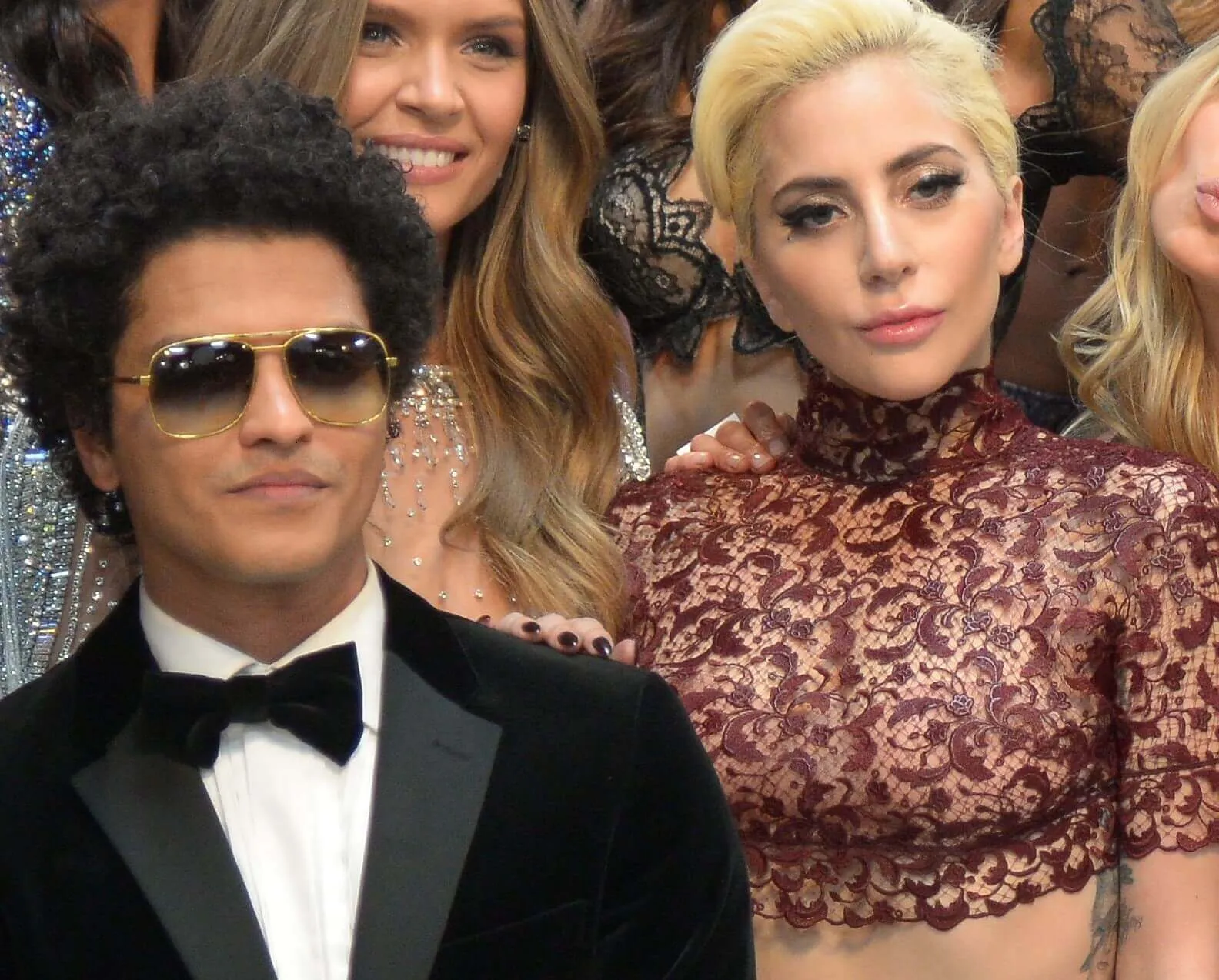 Bruno Mars standing next to Lady Gaga