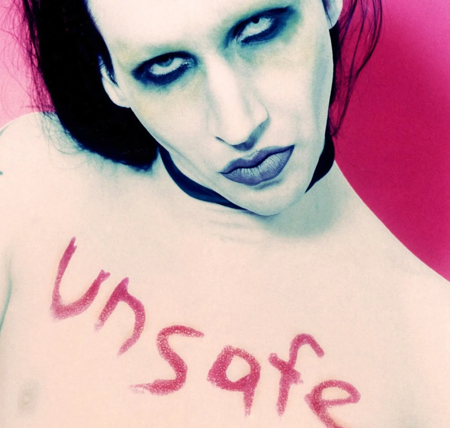 Marilyn Manson with the word "unsafe" on his chest