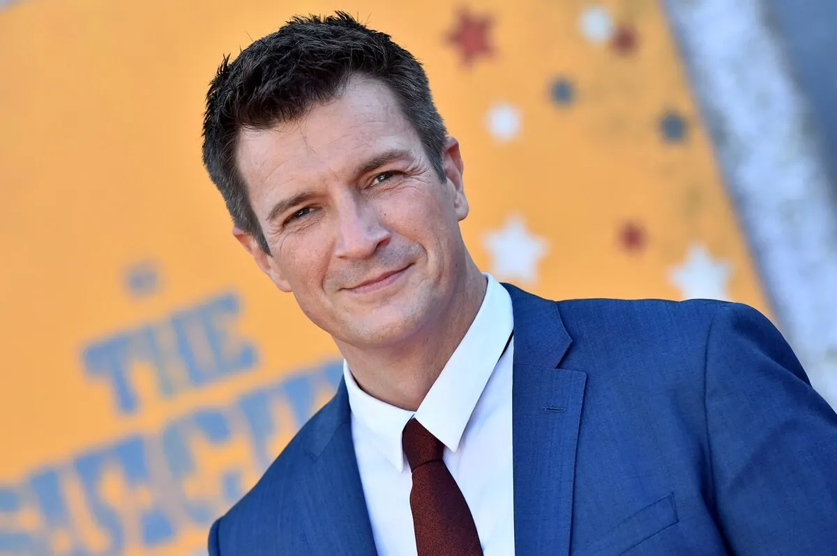 Nathan Fillion posing in a blue suit at 'The Suicide Squad' premiere.