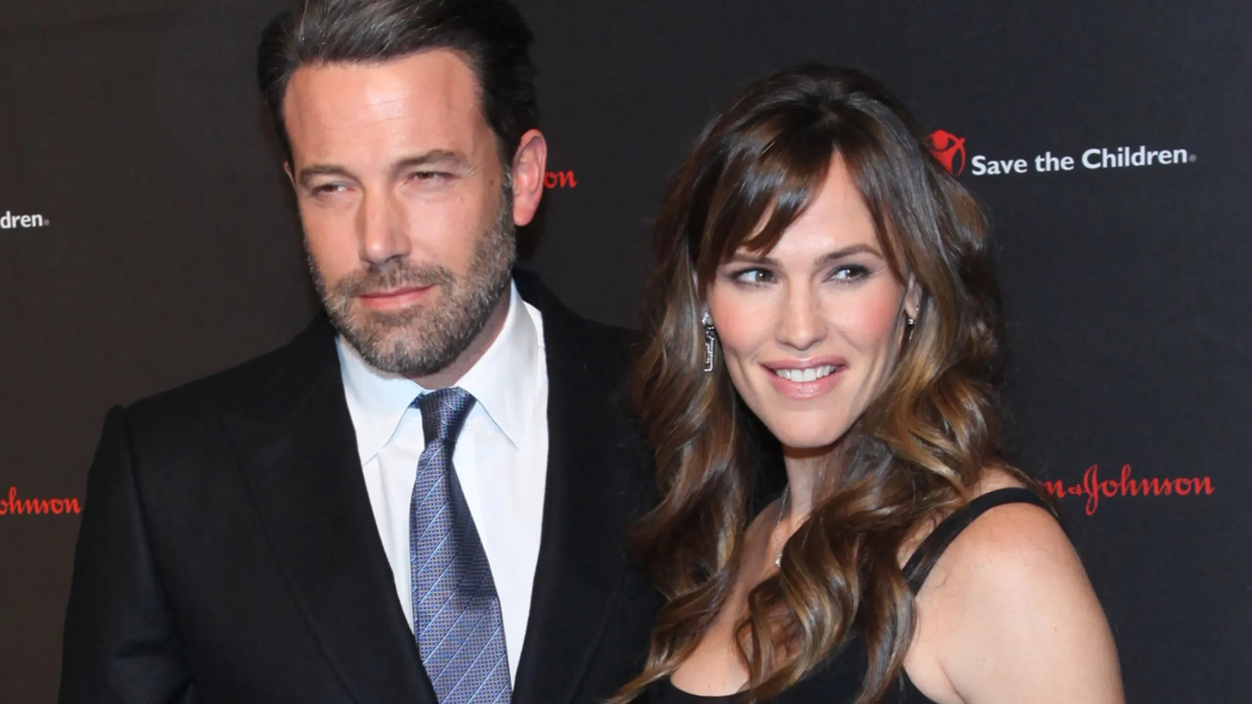 Then-couple Ben Affleck and Jennifer Garner stand together on a red carpet in 2014