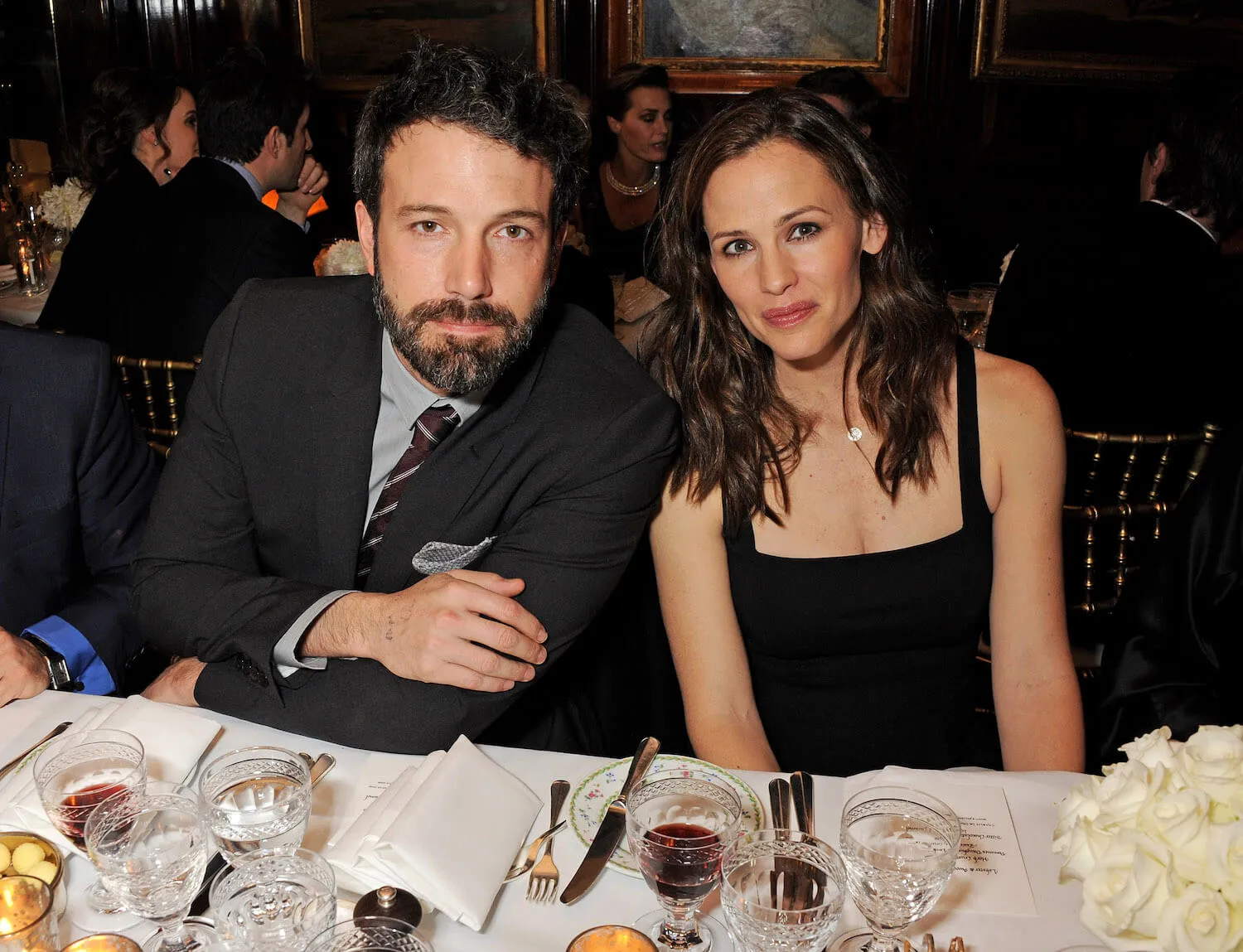 Ben Affleck and Jennifer Garner sitting next to each other at a cocktail party in 2013