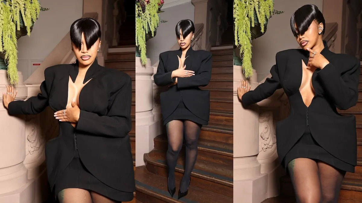 Wearing a black mini dress and blunt bangs, Cardi B poses for photographers before the Mugler spring/summer show 2025 fashion show in Paris