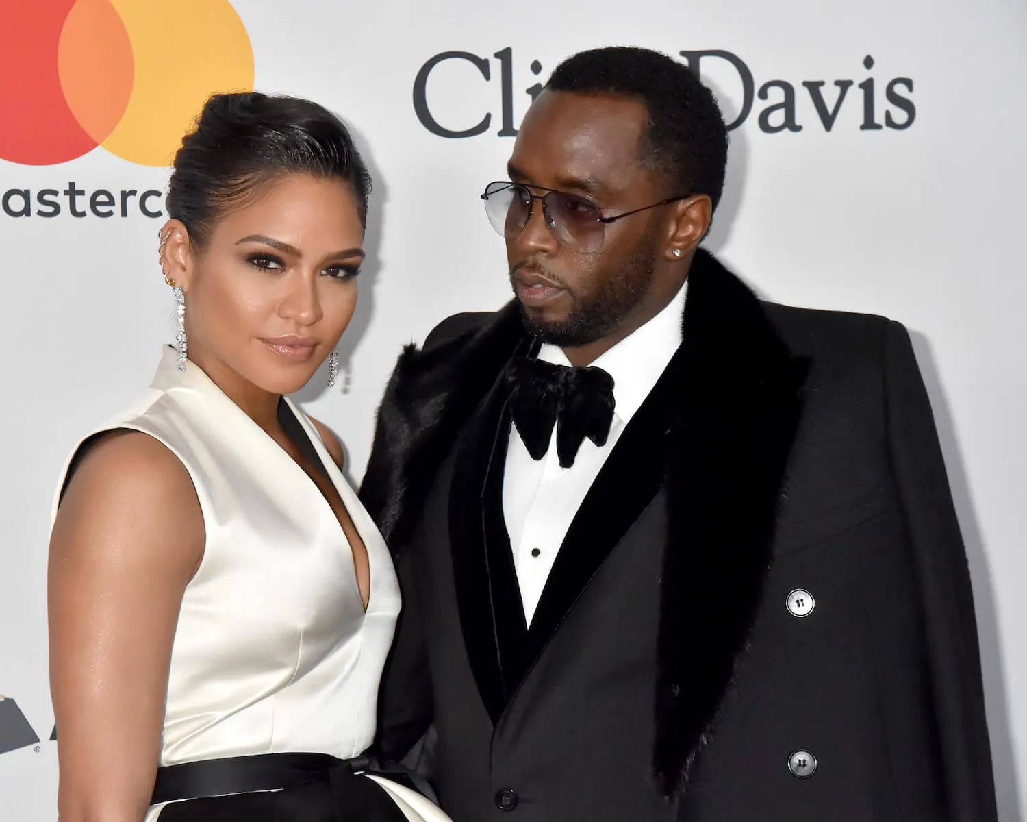 Casandra 'Cassie' Ventura wearing a black and white collared dress posing with Sean 'P. Diddy' Combs, who's in a tuxedo