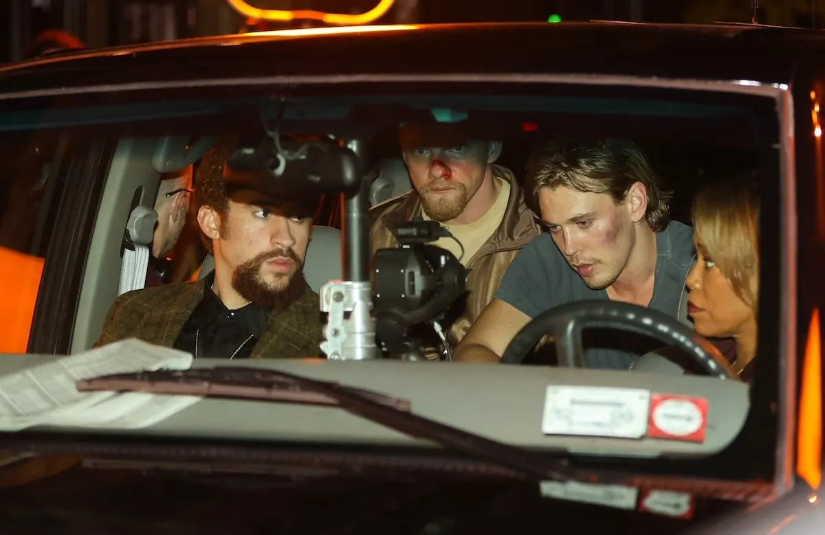 Actors Bad Bunny, Austin Butler, and Regina King film a scene in a car for Caught Stealing