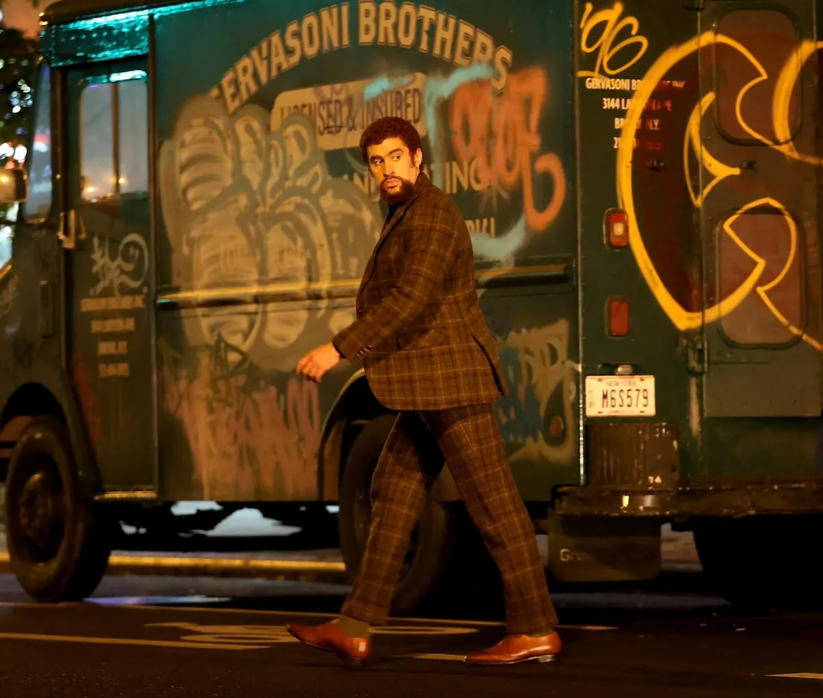 Wearing a brown plaid suit set, Bad Bunny films 'Caught Stealing' on a New York City street