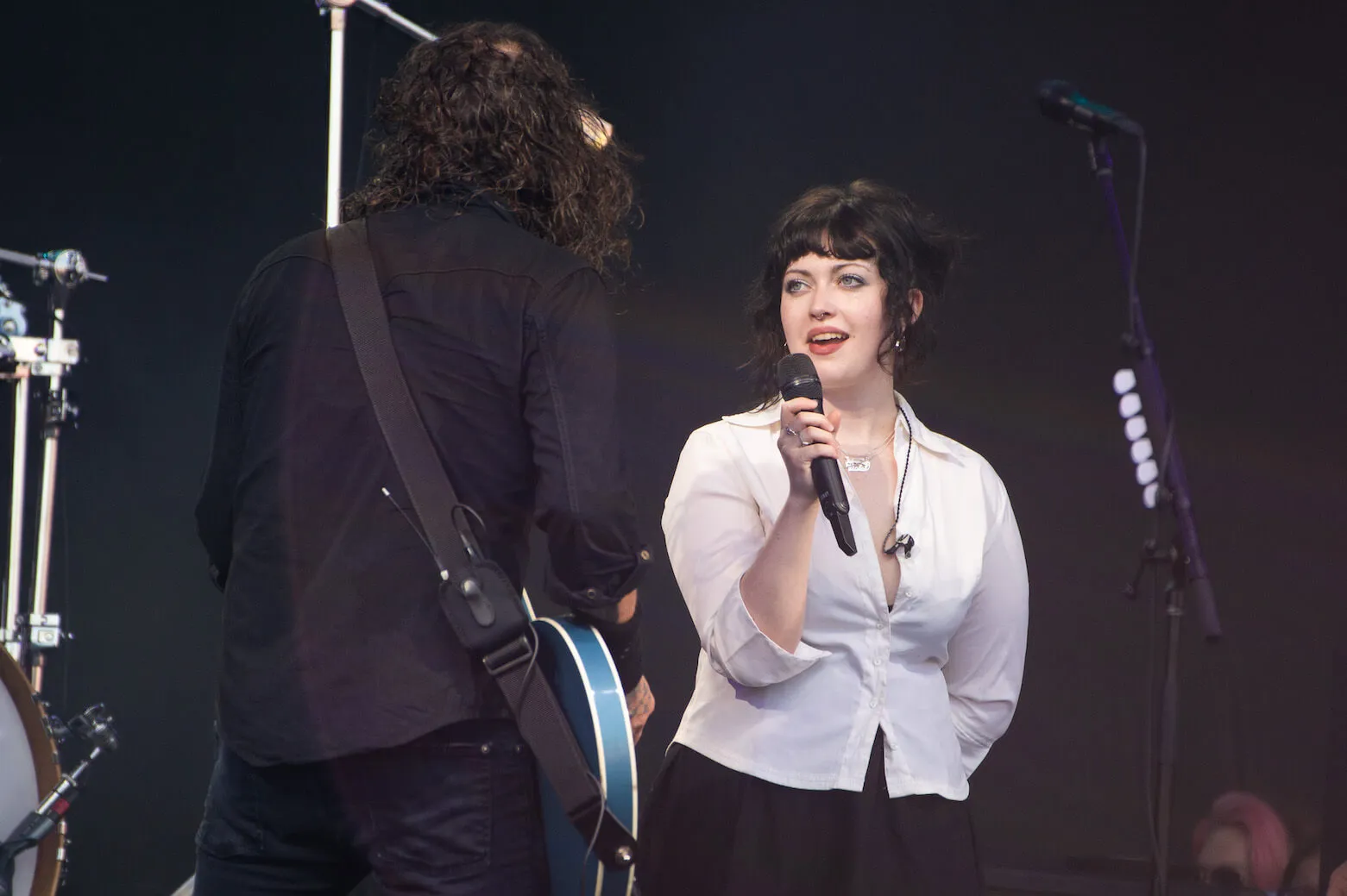 Dave Grohl facing his daughter, Violet Maye Grohl, as he plays guitar and she sings on stage