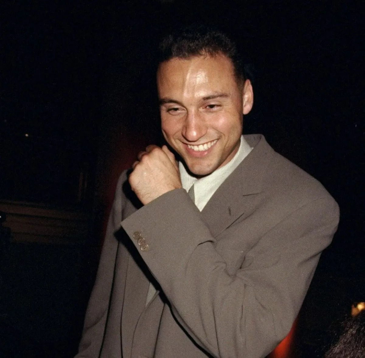 Derek Jeter wears a suit and smiles.