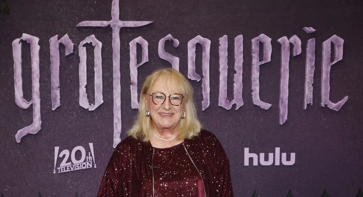 Donna Kelce standing in front of a backdrop reading 'Grotesquerie'