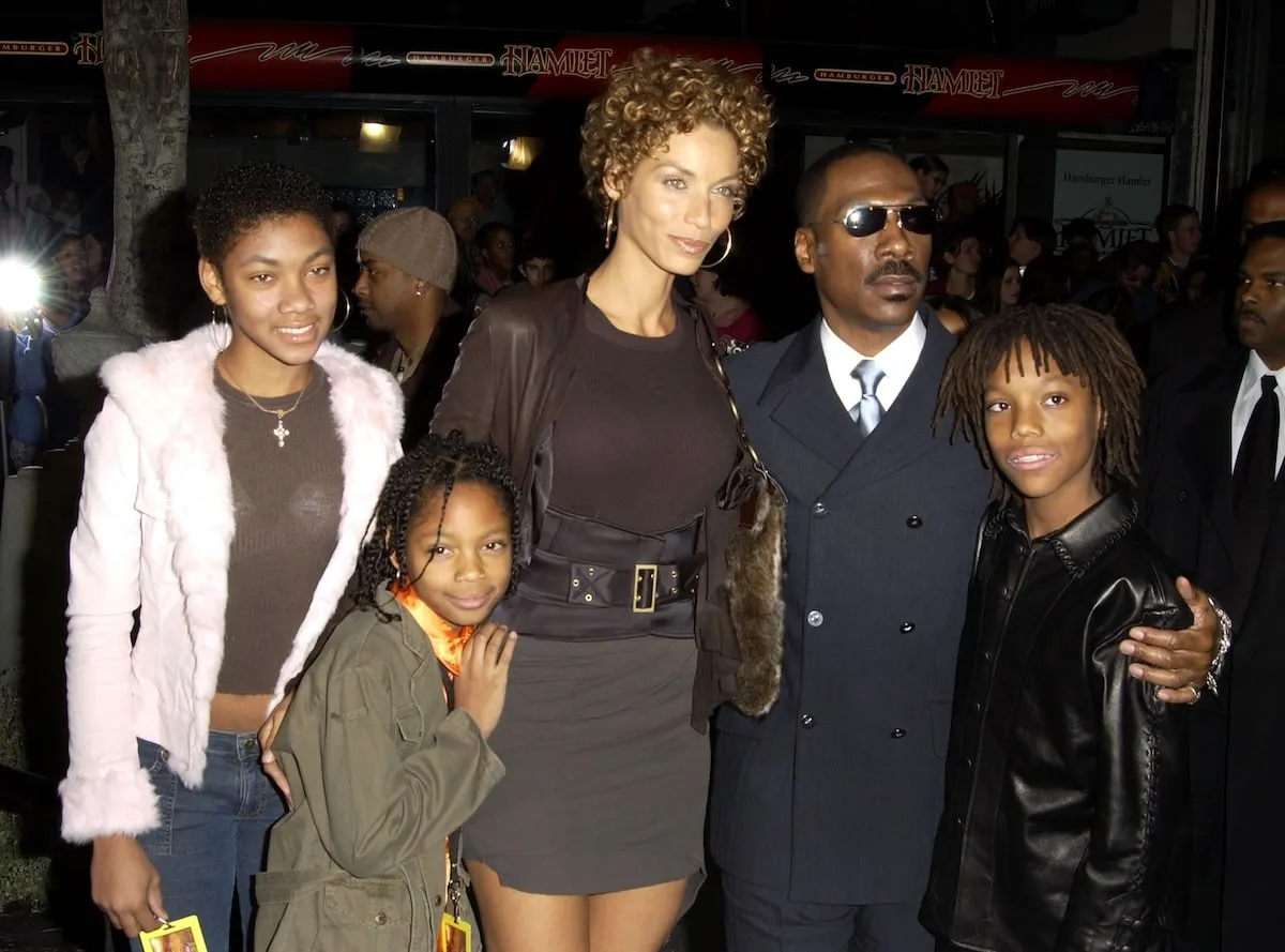 Eddie Murphy, Nicole Mitchell, and their children stand together at a movie premiere in 2003