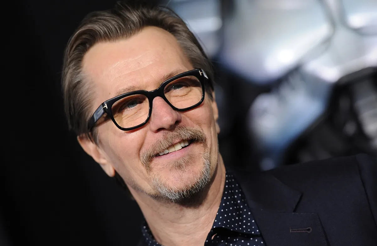 Gary Oldman arrives at the Los Angeles premiere of 'RoboCop' wearing a black suit.