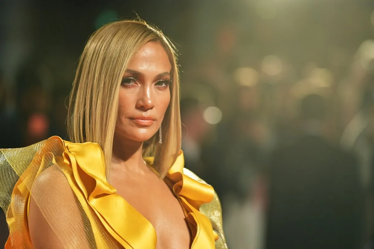 Jennifer Lopez attends the "Hustlers" premiere during the 2019 Toronto International Film Festival in a yellow dress.