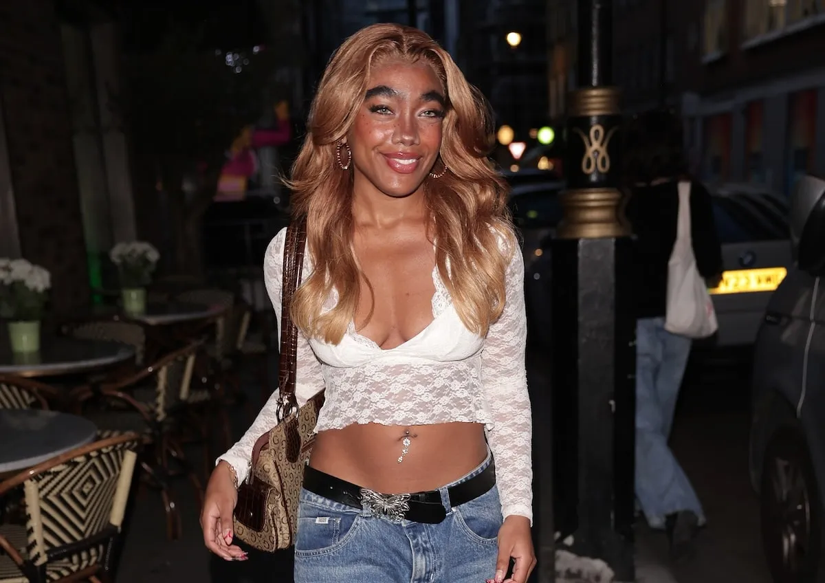 Influencer Marii King wears a white lace top and denim pants to a special dinner in London